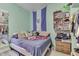 Cozy bedroom featuring a bed, eclectic decor, and a light blue accent wall at 952 Lasalle St, Indianapolis, IN 46201