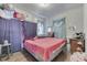 Bedroom showing hardwood floors, closet space, and a window providing natural light; in need of TLC at 952 Lasalle St, Indianapolis, IN 46201