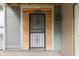 Close-up of the front door with decorative security door, house number, and weathered gray siding at 952 Lasalle St, Indianapolis, IN 46201