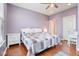 Cozy bedroom features hardwood floors, a ceiling fan, and ample natural light at 9682 Angelica Dr, Noblesville, IN 46060