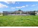 View of the community pool through the wrought iron fence and green lawn in a neighborhood setting at 9682 Angelica Dr, Noblesville, IN 46060