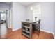 Charming dining area featuring a wooden table and chairs beneath a modern pendant light at 9682 Angelica Dr, Noblesville, IN 46060