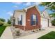 Charming home showcasing brick and vinyl siding, complemented by blue shutters and manicured landscaping at 9682 Angelica Dr, Noblesville, IN 46060