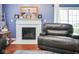 Close up on fireplace with decor, set against a blue accent wall in the living room at 9682 Angelica Dr, Noblesville, IN 46060