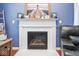 Decorative white fireplace with lighthouse art, complementing the stylish living room at 9682 Angelica Dr, Noblesville, IN 46060