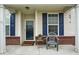 Cozy front porch featuring neutral siding, blue shutters, and a welcoming entrance at 9682 Angelica Dr, Noblesville, IN 46060