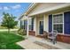 Inviting front porch with blue shutters, complemented by a well-maintained lawn and landscaping at 9682 Angelica Dr, Noblesville, IN 46060