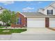 Two-car garage with brick accents and vinyl siding, set against a blue sky backdrop at 9682 Angelica Dr, Noblesville, IN 46060