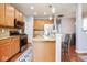 Spacious kitchen boasts stainless steel appliances, ample wooden cabinetry, and a stylish breakfast bar at 9682 Angelica Dr, Noblesville, IN 46060