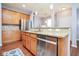 The kitchen features stainless steel appliances, wooden cabinets, and an inviting breakfast bar with granite countertops at 9682 Angelica Dr, Noblesville, IN 46060