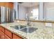 Bright kitchen sink with granite countertop, stainless steel appliances, and convenient breakfast bar area at 9682 Angelica Dr, Noblesville, IN 46060