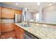 Well-appointed kitchen featuring wood cabinets, granite countertops, stainless steel appliances, and a breakfast bar area at 9682 Angelica Dr, Noblesville, IN 46060