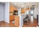 Well-lit kitchen featuring wooden cabinets, granite countertops, stainless steel appliances and breakfast bar at 9682 Angelica Dr, Noblesville, IN 46060