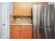 Kitchen features stainless steel refrigerator, granite counters, and light wood cabinets at 9682 Angelica Dr, Noblesville, IN 46060