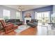 Bright living room with leather seating, fireplace, and sliding glass doors to the patio at 9682 Angelica Dr, Noblesville, IN 46060