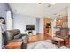 Open-concept living room showcases hardwood floors, a TV, and seamless flow to the kitchen at 9682 Angelica Dr, Noblesville, IN 46060