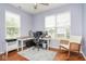 Home office features hardwood floors, a double window, an office chair and wooden desk at 9682 Angelica Dr, Noblesville, IN 46060