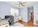 Home office features hardwood floors, windows, an office chair and wooden desk at 9682 Angelica Dr, Noblesville, IN 46060