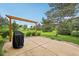 Spacious backyard patio with a built-in grill, ideal for outdoor dining at 9833 Parkshore Dr, Fishers, IN 46038