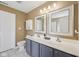 Bathroom featuring a double vanity, framed mirrors, ample lighting, and a separate toilet room at 9833 Parkshore Dr, Fishers, IN 46038