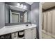 Bathroom featuring a gray wall, white countertop and cabinet, and large mirror at 9833 Parkshore Dr, Fishers, IN 46038