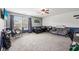 Spacious bedroom boasts gray carpeting, two windows, a seating area, and a bed at 9833 Parkshore Dr, Fishers, IN 46038