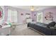 Charming bedroom with soft purple walls, chair, and plush gray carpet at 9833 Parkshore Dr, Fishers, IN 46038
