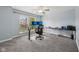 Bright bedroom features two work stations, modern ceiling fan, and gray carpeting throughout at 9833 Parkshore Dr, Fishers, IN 46038