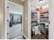 Well-organized walk-in closet with wire shelving and laminate flooring and a view to an adjacent room at 9833 Parkshore Dr, Fishers, IN 46038