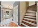 The entryway features a staircase, hardwood floors, and ample natural lighting at 9833 Parkshore Dr, Fishers, IN 46038