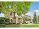 Beautiful brick home with manicured lawn, mature trees, and inviting covered porch at 9833 Parkshore Dr, Fishers, IN 46038