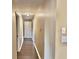 Hallway with consistent flooring, neutral walls, white trim, and access to multiple rooms at 9833 Parkshore Dr, Fishers, IN 46038