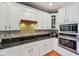 This modern kitchen features white cabinets, stainless steel appliances, and a granite countertop at 9833 Parkshore Dr, Fishers, IN 46038