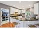 This kitchen has granite countertops, white cabinets, an island with stools, and stainless appliances at 9833 Parkshore Dr, Fishers, IN 46038