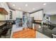 Well-lit kitchen boasts stainless appliances, granite counters, and hardwood floors at 9833 Parkshore Dr, Fishers, IN 46038