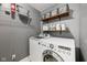 Modern laundry room with gray walls, shelves, and LG washer and dryer units at 9833 Parkshore Dr, Fishers, IN 46038