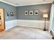 Living room featuring neutral decor, wainscoting, and great natural light at 9833 Parkshore Dr, Fishers, IN 46038