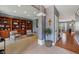 Inviting living room features custom built-ins, neutral tones and access to the entryway and stairs at 9833 Parkshore Dr, Fishers, IN 46038