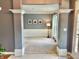 Open living room with large entryways, wainscotting, and neutral decor at 9833 Parkshore Dr, Fishers, IN 46038