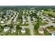 An aerial view of a neighborhood with tree-lined streets, well-manicured lawns, and diverse home styles near a pond at 101 Meadowview Dr, Mooresville, IN 46158