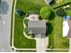 Aerial view of the landscaped backyard featuring a stone patio and well-manicured lawn at 101 Meadowview Dr, Mooresville, IN 46158