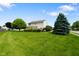 Expansive backyard featuring a well-manicured lawn and mature landscaping, offering privacy at 101 Meadowview Dr, Mooresville, IN 46158