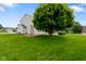 Spacious backyard featuring mature trees, well-kept lawn, and a patio area perfect for outdoor enjoyment at 101 Meadowview Dr, Mooresville, IN 46158