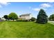 Expansive backyard featuring a lush lawn, mature trees, and a wooden deck perfect for outdoor entertaining at 101 Meadowview Dr, Mooresville, IN 46158