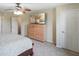 Carpeted bedroom featuring dresser with TV, ceiling fan, two windows with curtains, and light colored walls at 101 Meadowview Dr, Mooresville, IN 46158