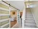 A welcoming foyer with stylish sliding doors, a staircase, and tasteful decor at 101 Meadowview Dr, Mooresville, IN 46158