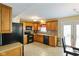 Bright eat-in kitchen with wooden cabinets, black appliances, and sliding glass doors at 101 Meadowview Dr, Mooresville, IN 46158