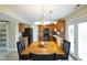 Bright eat-in kitchen with wooden cabinets, black appliances, and chandelier at 101 Meadowview Dr, Mooresville, IN 46158