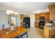 Eat-in kitchen with wooden cabinets, black appliances, and tile flooring at 101 Meadowview Dr, Mooresville, IN 46158