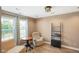 A sunlit living room with neutral walls, wood floors, comfortable seating, and modern lighting at 101 Meadowview Dr, Mooresville, IN 46158